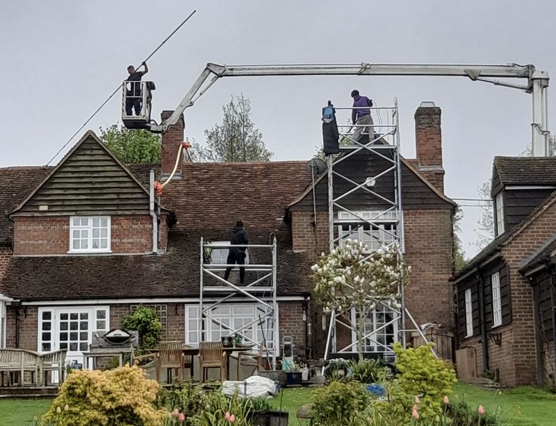 The Roof Moss Cleaners using cherry picker and scaffolding to clean roof safely and professionally in Emsworth, Hampshire
